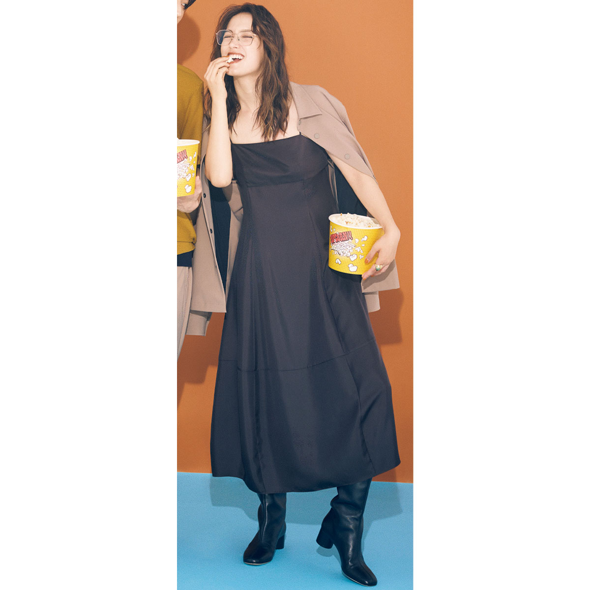 黒のキャミワンピにメンズのコーチジャケットの肩掛けコーデ