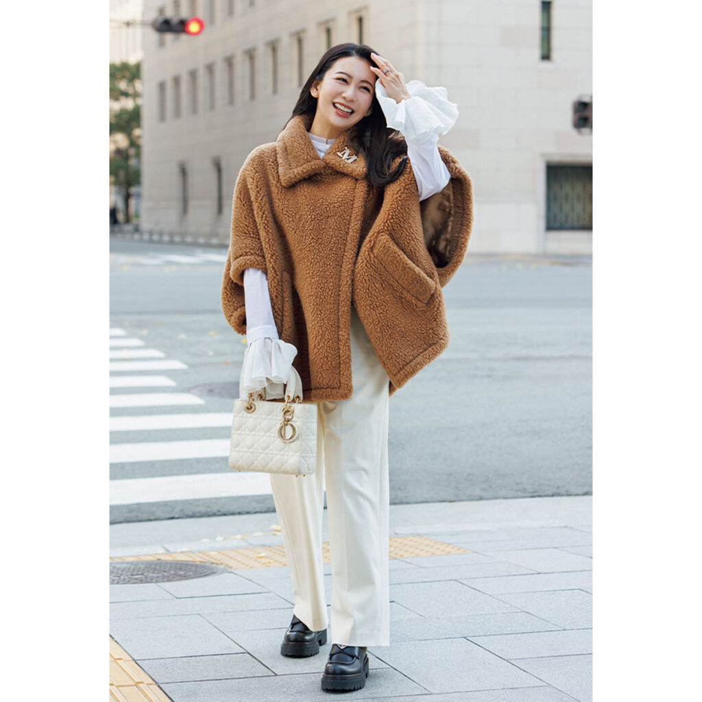 キャメルのケープタイプのテディと白パンツのコーデ