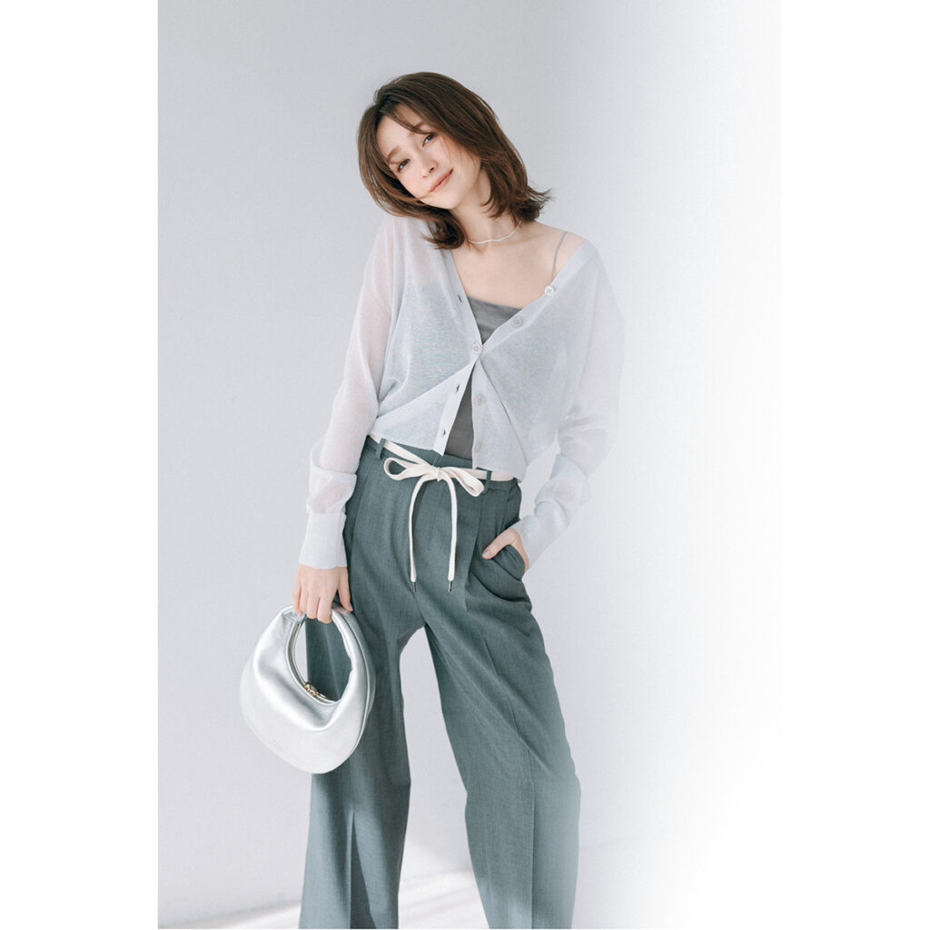 グレーのスラックスにシアーカーデのコーデ